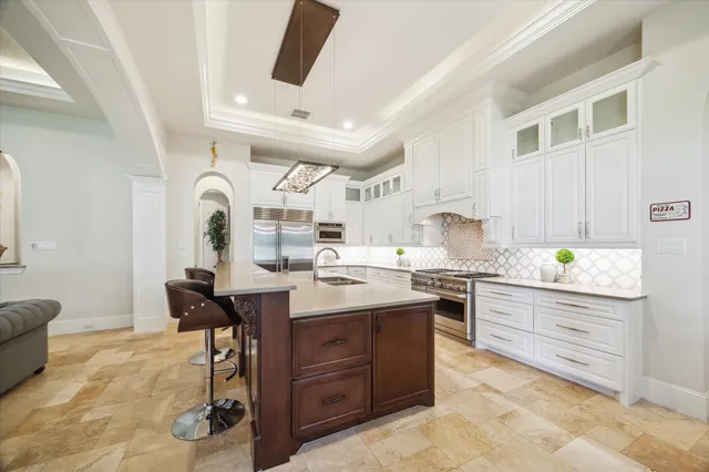 a kitchen with stainless steel appliances granite countertop a sink stove and cabinets