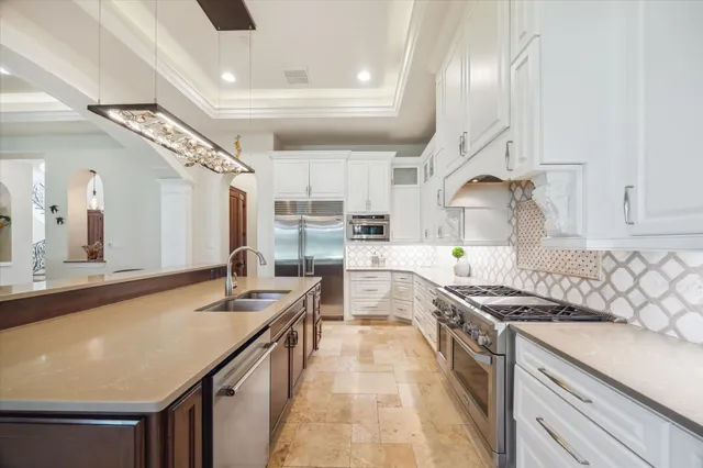 a kitchen with a stove and a large window