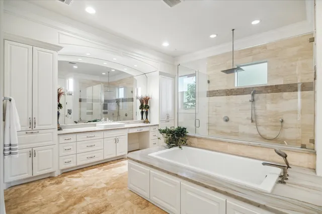 a bathroom with a sink double vanity granite tub shower and a mirror