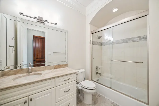 a bedroom with a bed chandelier and a window
