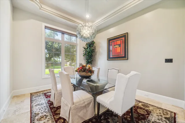 a view of a dining room with furniture wooden floor and a chandelier