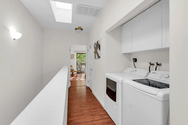 a kitchen with a sink and wooden floor