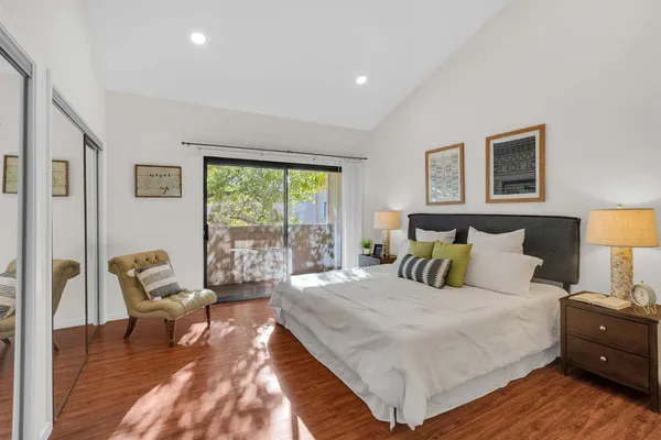 a bedroom with a bed and a large window