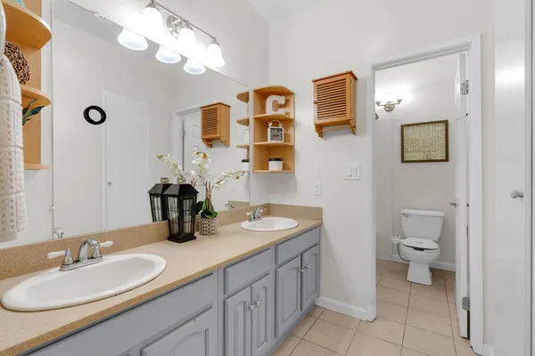 a bathroom with a toilet a sink and mirror