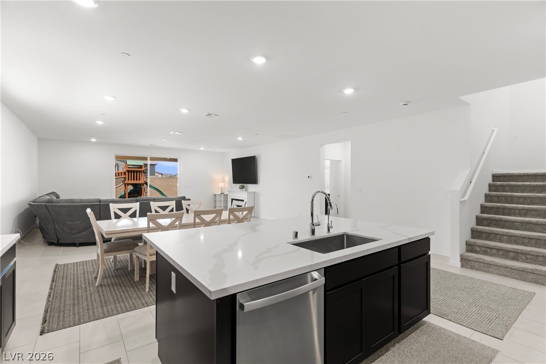 320 Isla Enclave Way Henderson, NV 89011 - Photo 5 of 49 This spacious open-concept living area blends a well-appointed kitchen island with an inviting dining and lounge space.