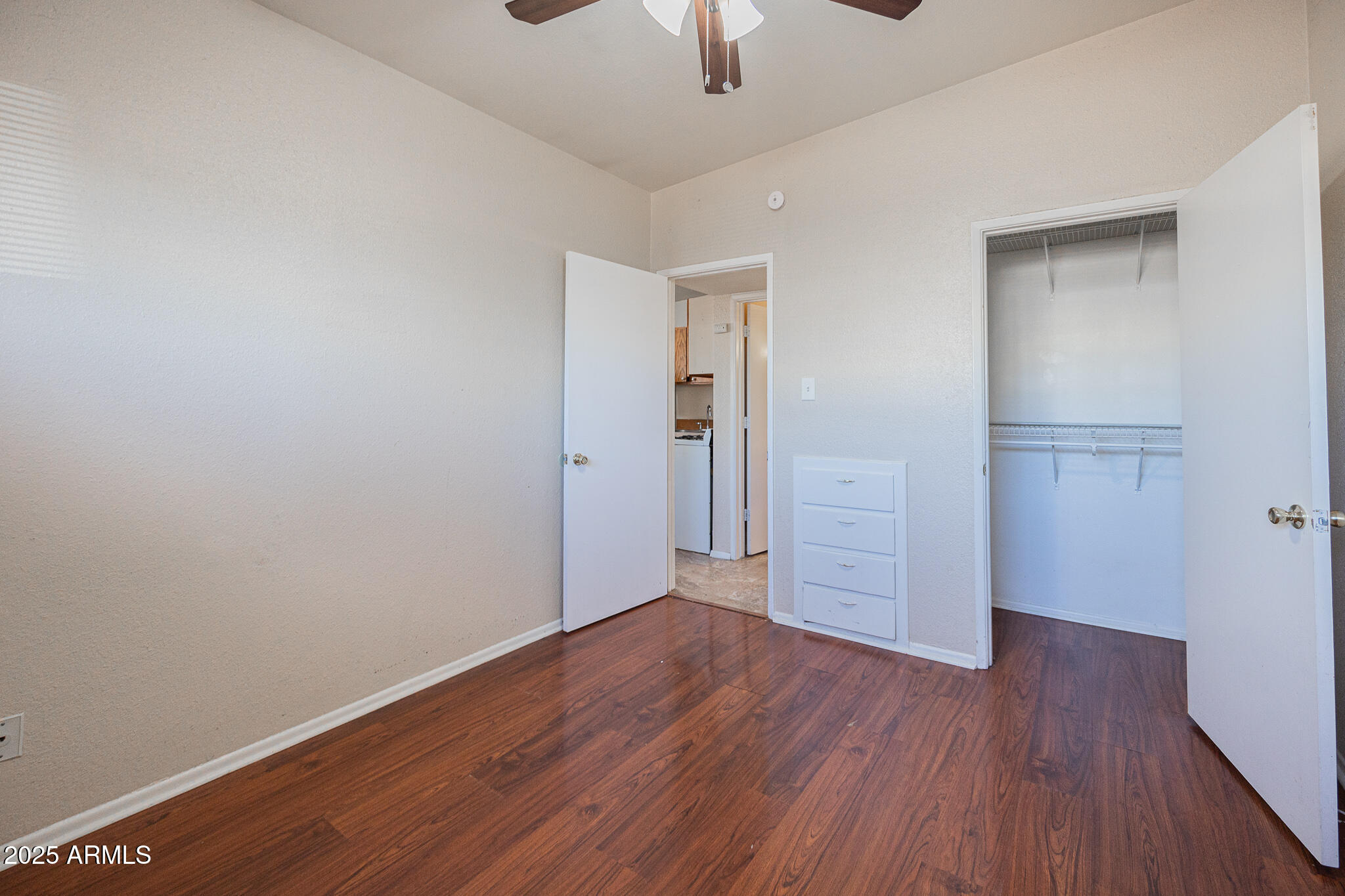 903 South Kenwood Circle, Unit 1 Tempe, AZ 85281 - Photo 14 of 15 an empty room with wooden floor cabinet and windows