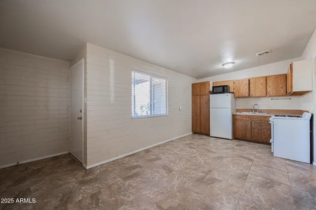a view of a kitchen with a sink cabinet and a refrigerator