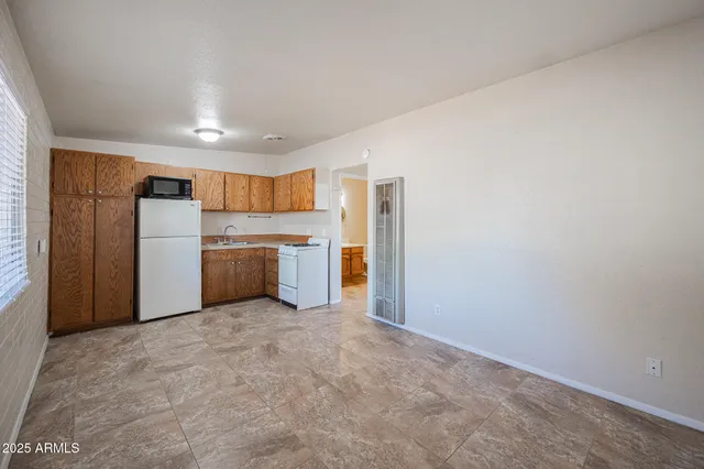 a view of a kitchen with a microwave and a stove top oven