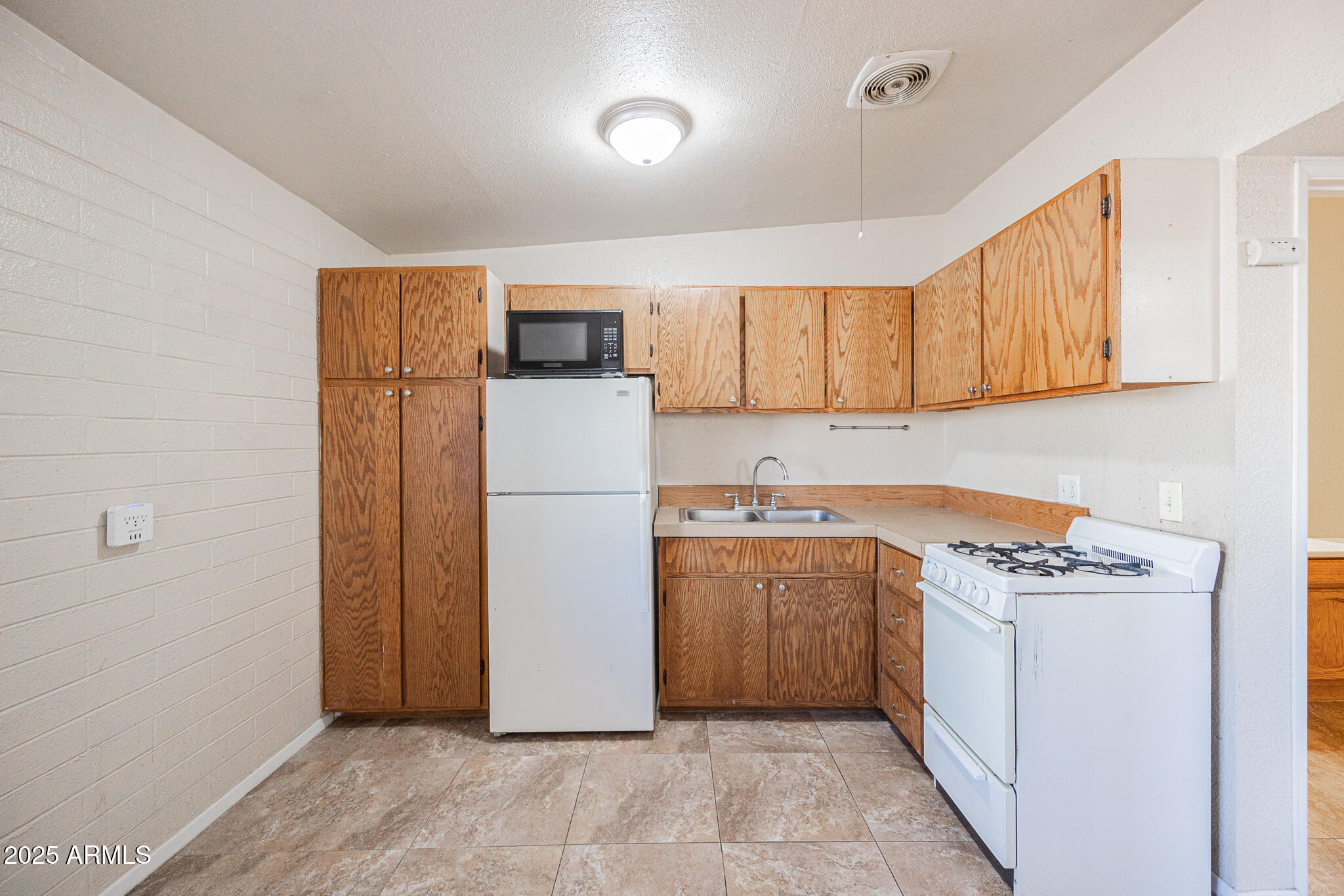 903 South Kenwood Circle, Unit 1 Tempe, AZ 85281 - Photo 9 of 15 a utility room with cabinets washer and dryer
