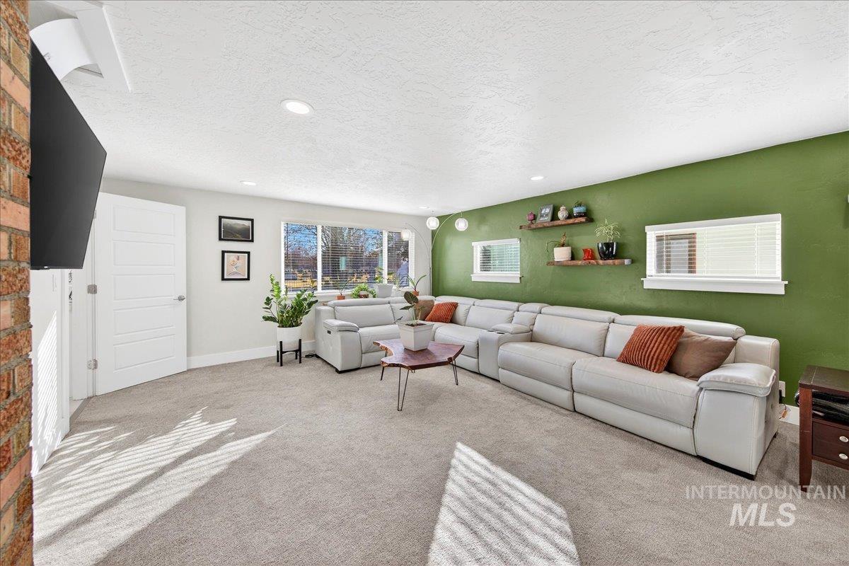 621 North Roosevelt Street Boise, ID 83706 - Photo 11 of 32 Living room featuring a textured ceiling, carpet floors, and recessed lighting