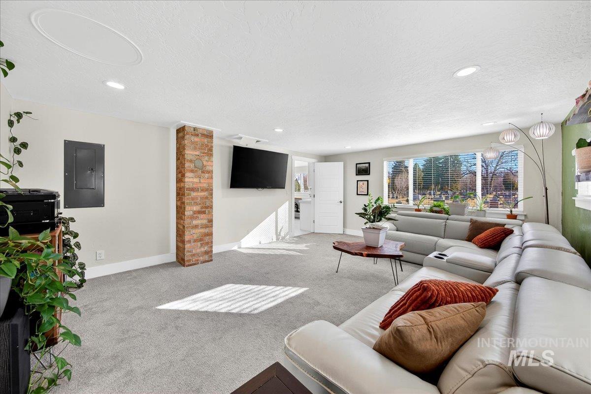 621 North Roosevelt Street Boise, ID 83706 - Photo 12 of 32 Living room with electric panel, carpet floors, a textured ceiling, and recessed lighting