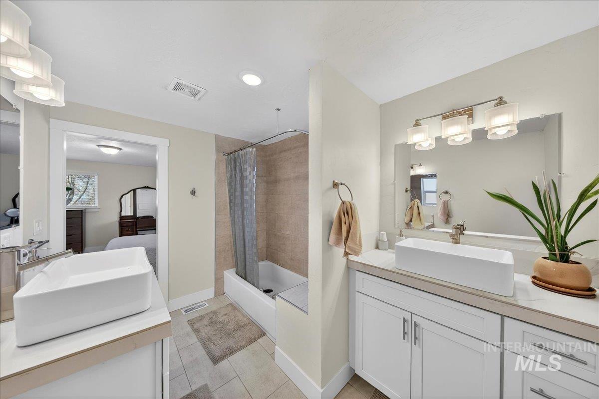 621 North Roosevelt Street Boise, ID 83706 - Photo 15 of 32 Bathroom with vanity, light tile patterned floors, and ensuite bathroom