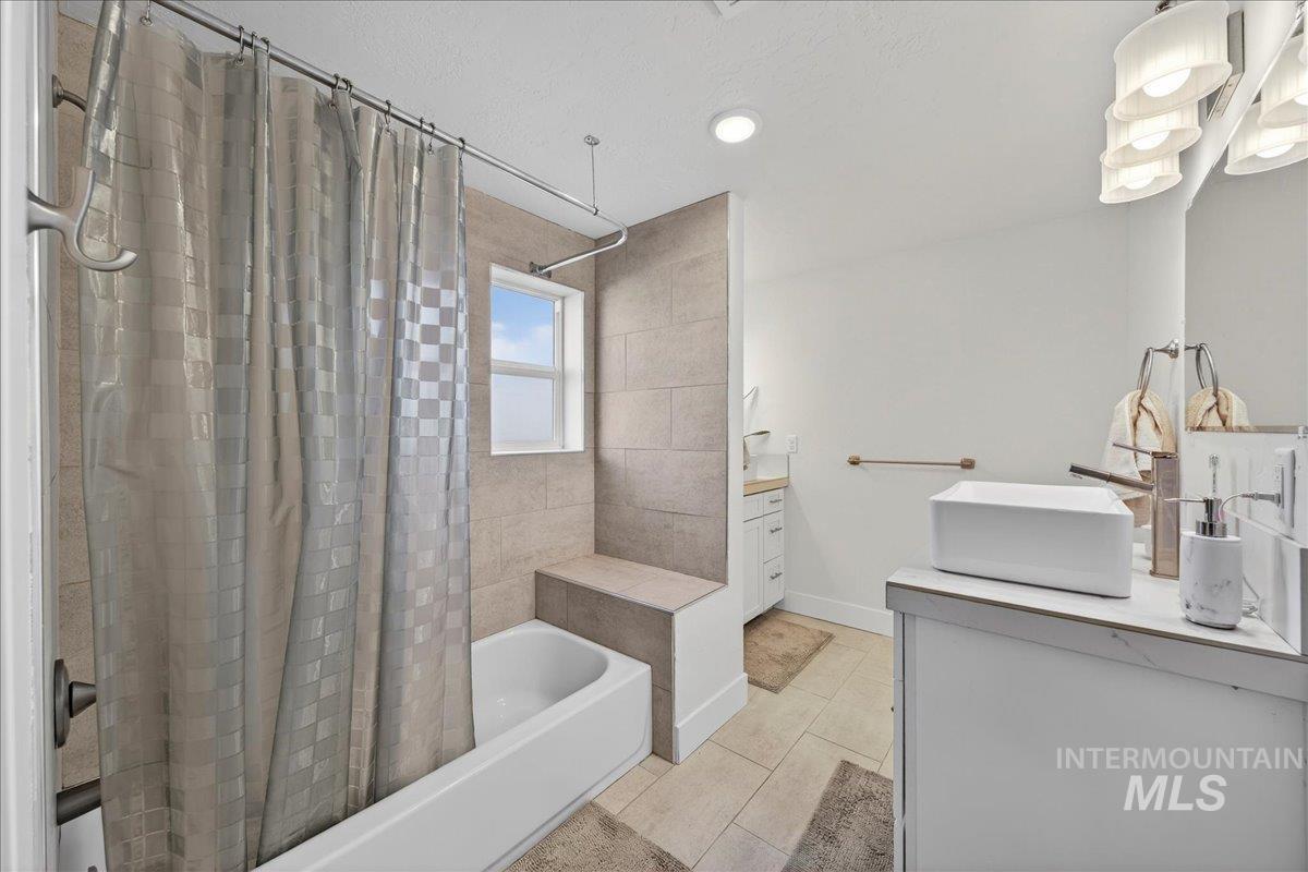 621 North Roosevelt Street Boise, ID 83706 - Photo 16 of 32 Bathroom with vanity, shower / tub combo, light tile patterned floors, and recessed lighting