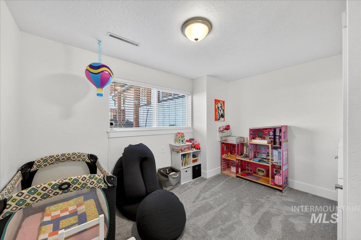 621 North Roosevelt Street Boise, ID 83706 - Photo 18 of 32 Bedroom space featuring carpet flooring and a textured ceiling