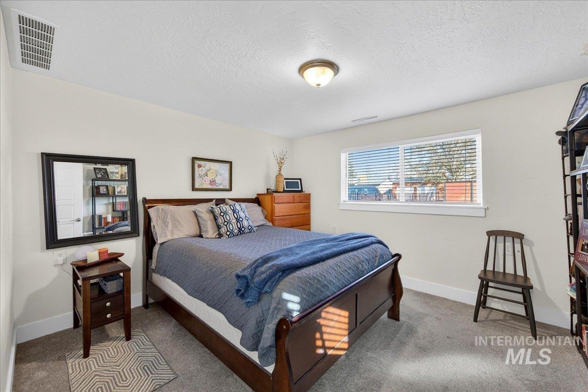 621 North Roosevelt Street Boise, ID 83706 - Photo 20 of 32 Carpeted bedroom featuring baseboards and a textured ceiling