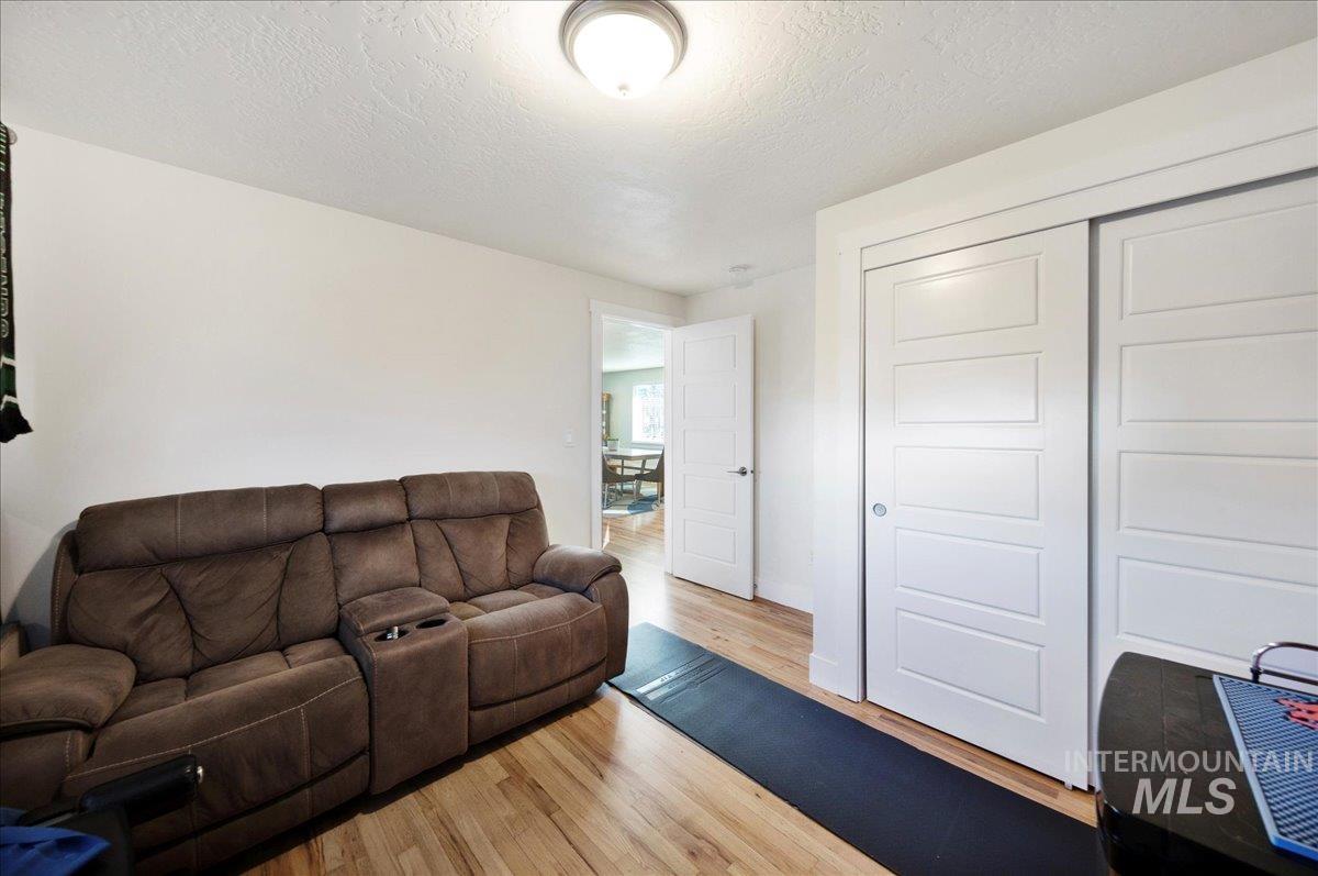 621 North Roosevelt Street Boise, ID 83706 - Photo 23 of 32 Living area with light wood-style floors and a textured ceiling