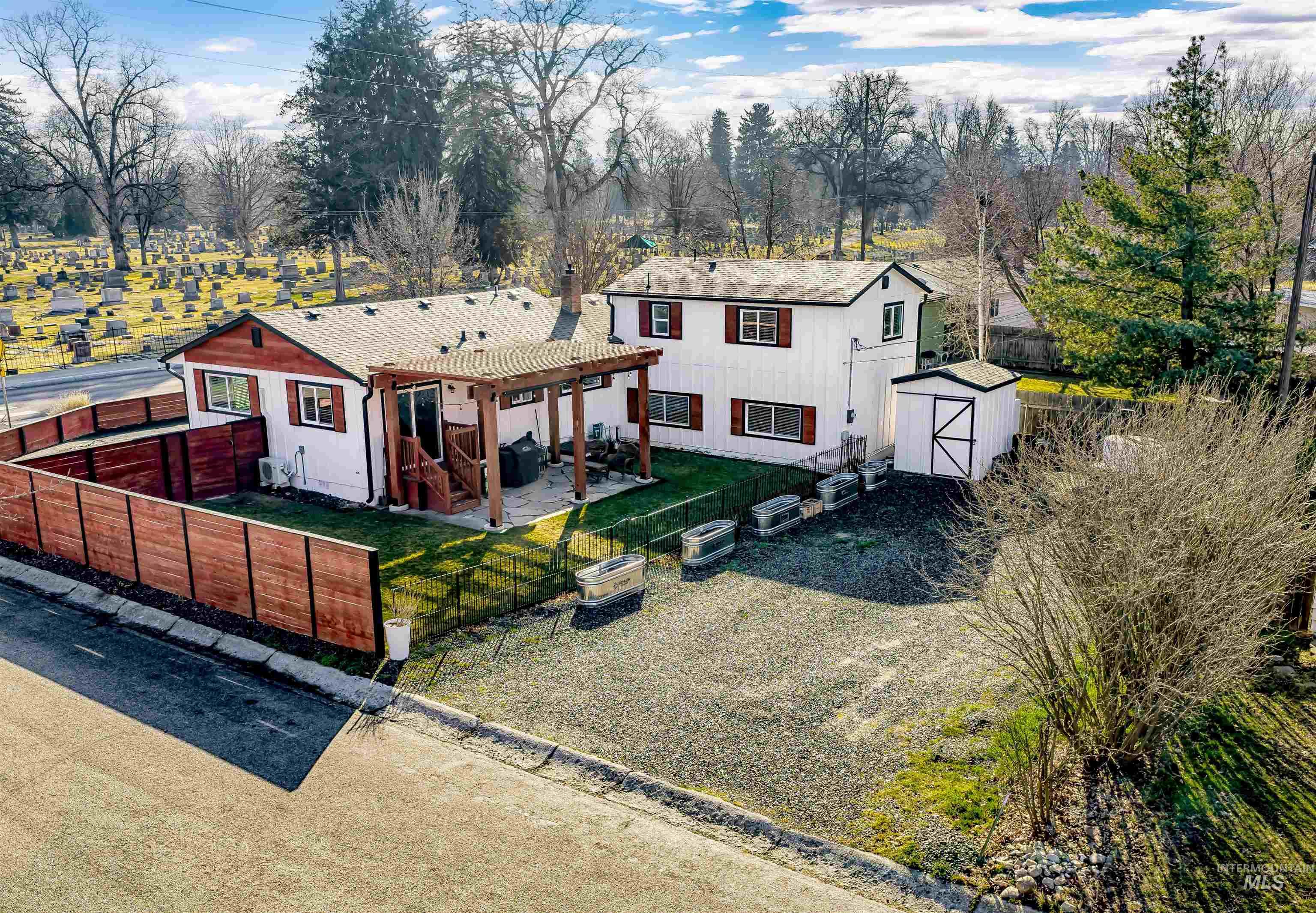 621 North Roosevelt Street Boise, ID 83706 - Photo 29 of 32 View of front of home featuring a fenced backyard, a storage unit, a patio area, and a shingled roof