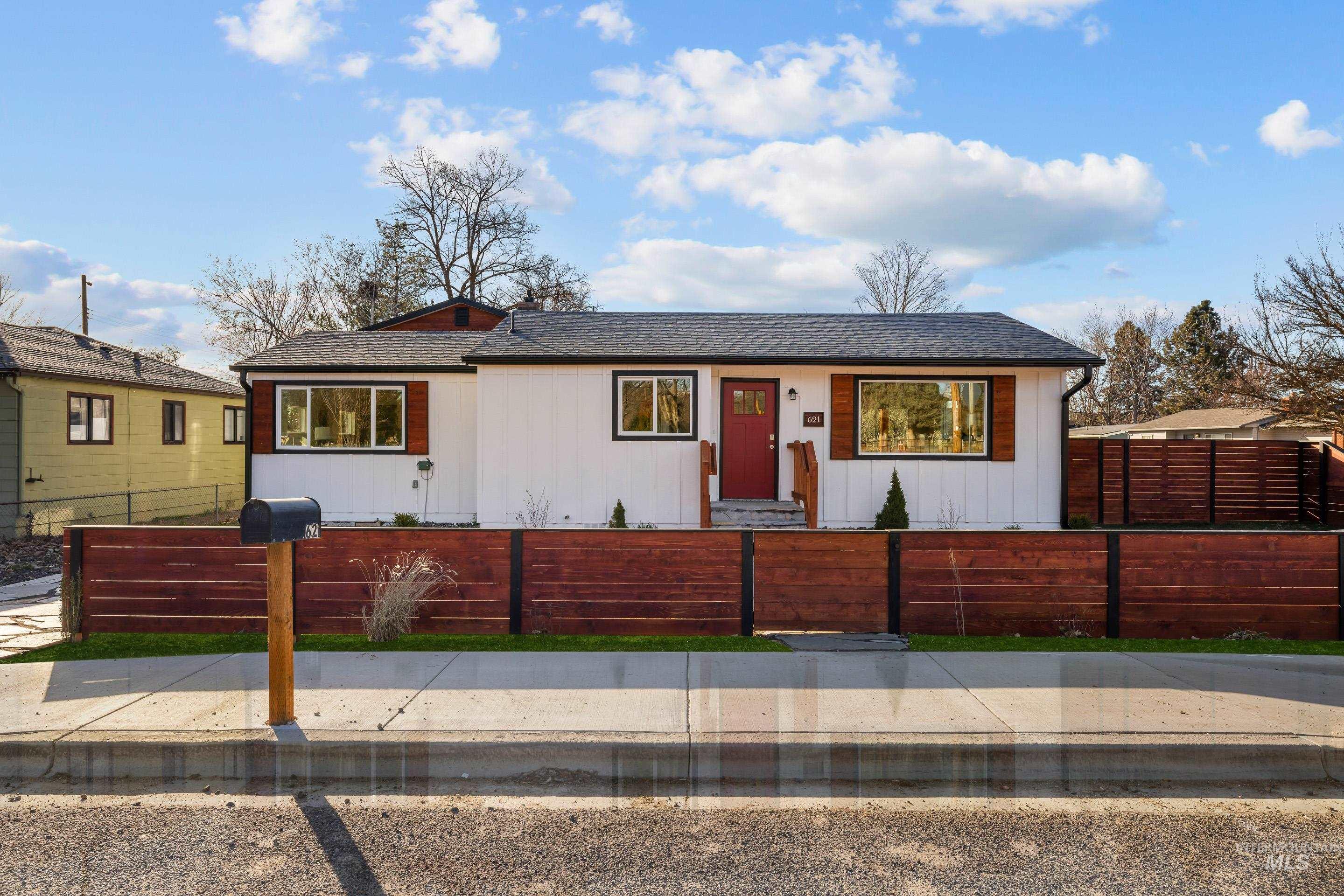 621 North Roosevelt Street Boise, ID 83706 - Photo 32 of 32 View of front of home with a fenced front yard, a shingled roof, and board and batten siding