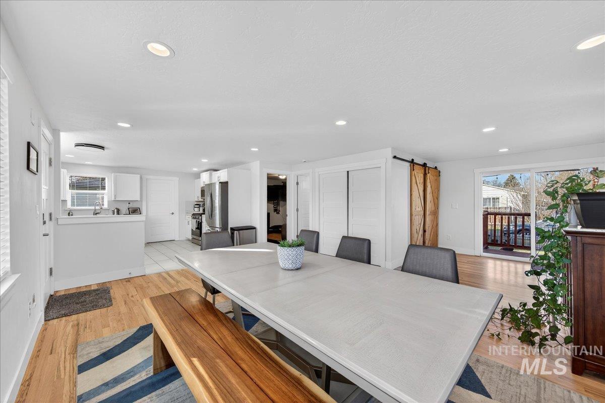621 North Roosevelt Street Boise, ID 83706 - Photo 6 of 32 Dining room with a barn door, light wood finished floors, plenty of natural light, and recessed lighting