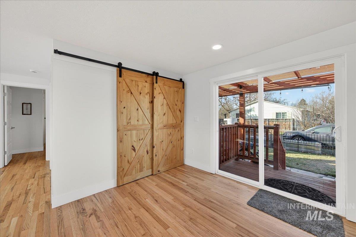 621 North Roosevelt Street Boise, ID 83706 - Photo 9 of 32 Doorway featuring a barn door, wood finished floors, and recessed lighting