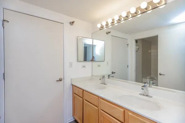 a bathroom with a double vanity sink and a mirror