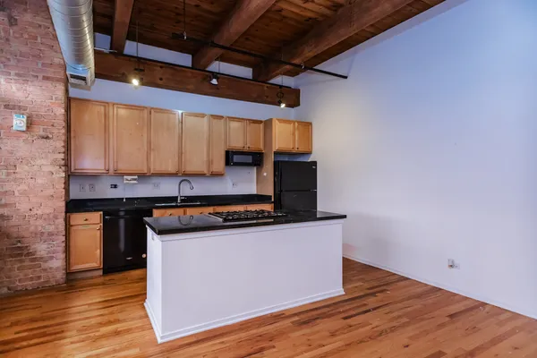 a kitchen with wooden floors and a sink