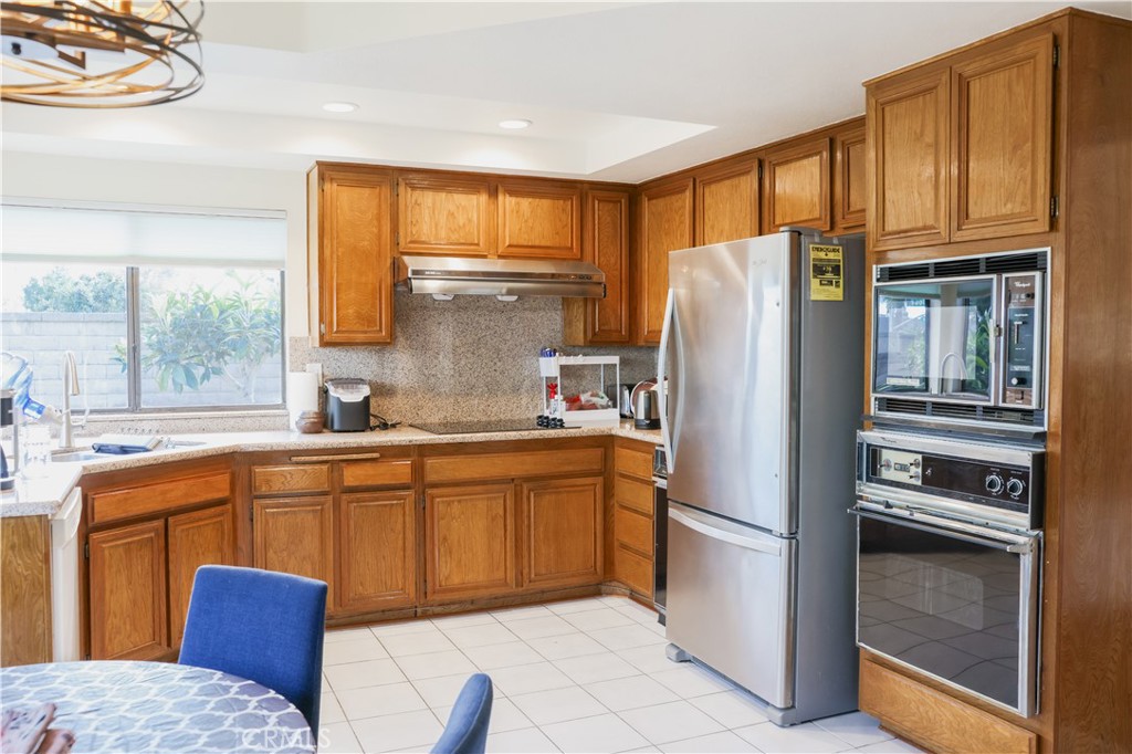 183 South Starflower Street Brea, CA 92821 - Photo 11 of 29 a kitchen with stainless steel appliances granite countertop a refrigerator and a sink
