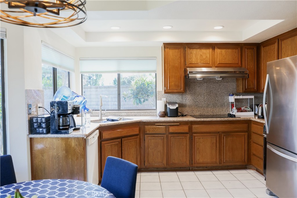 183 South Starflower Street Brea, CA 92821 - Photo 12 of 29 a kitchen with stainless steel appliances a sink stove and refrigerator