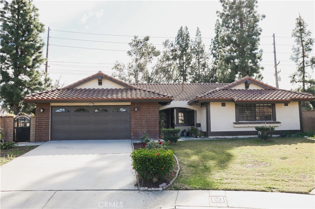 183 South Starflower Street Brea, CA 92821 - Photo 29 of 29 a front view of a house with a yard and garage