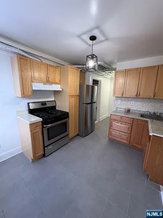 a kitchen with stainless steel appliances granite countertop a stove and a refrigerator