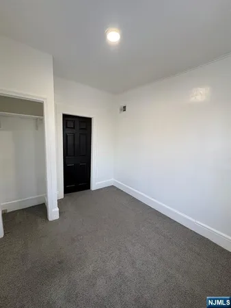 an empty room with an empty space and bathroom
