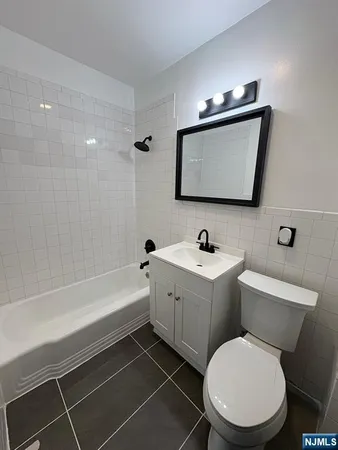 a bathroom with a toilet a sink and bathtub