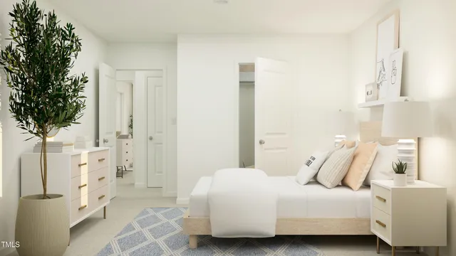 a bedroom with a bed and a potted plant