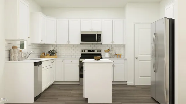 a kitchen with a refrigerator stove and white cabinets