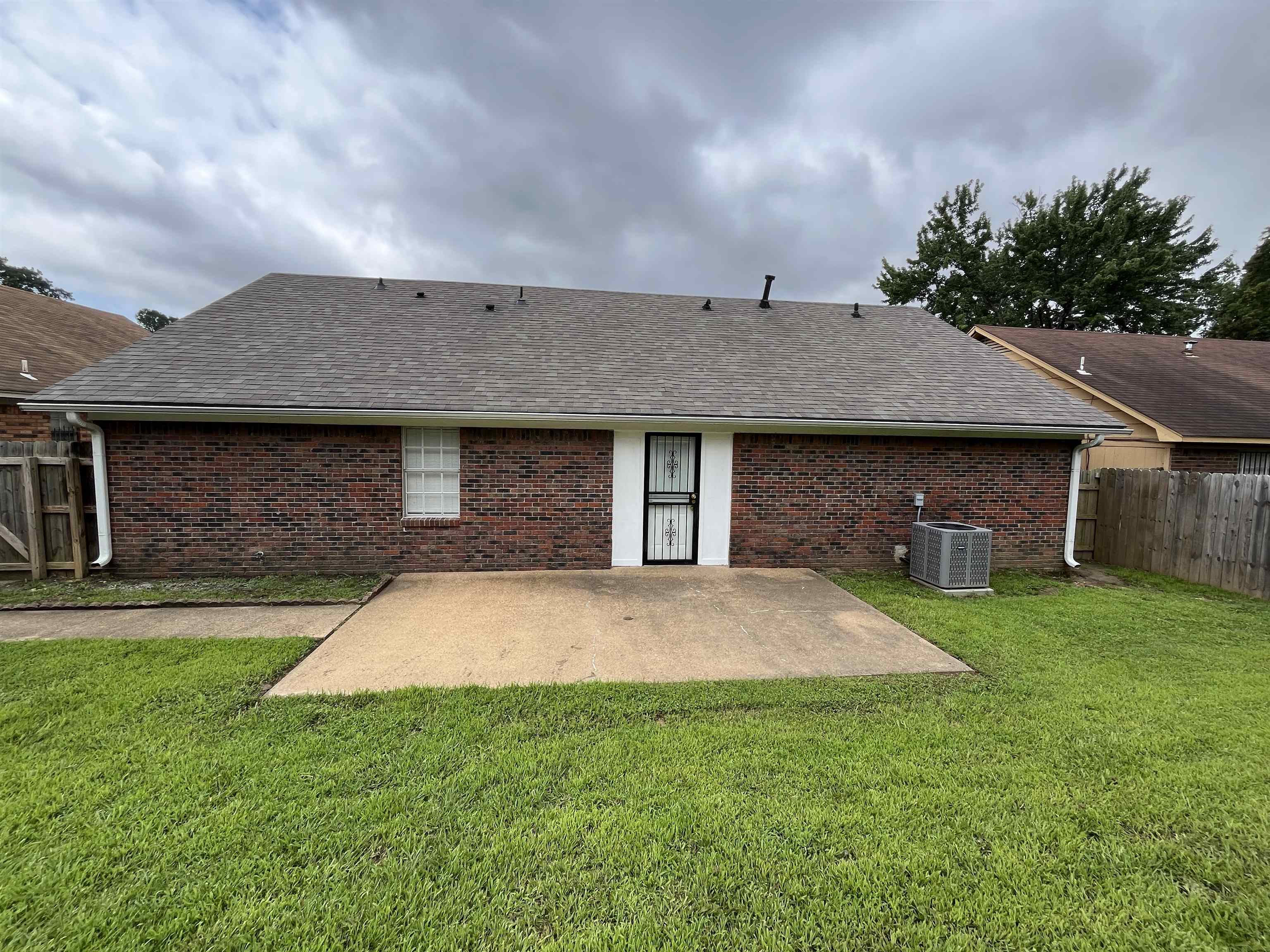 3016 Meadowfair Road Memphis, TN 38118 - Photo 12 of 17 Rear view of property featuring a patio area, brick siding, and roof with shingles