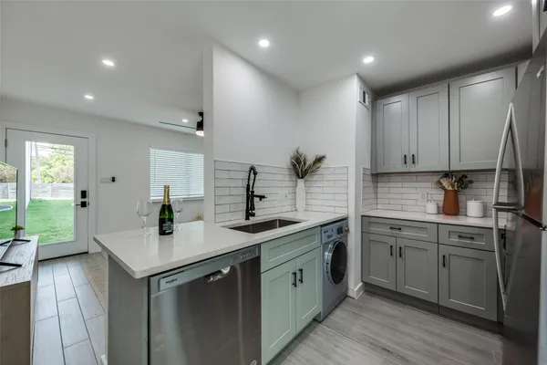 a kitchen with sink and cabinets