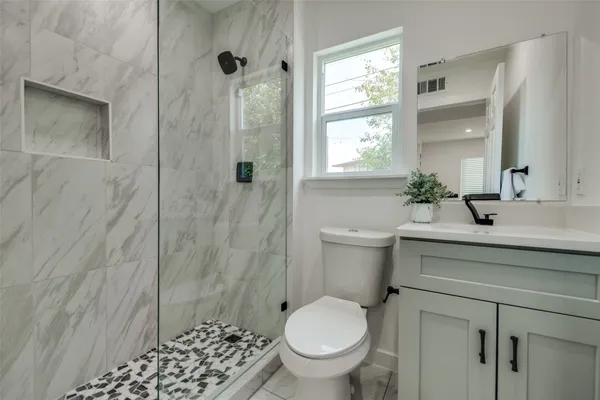 a bathroom with a sink toilet and shower