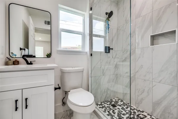 a bathroom with a sink toilet and shower