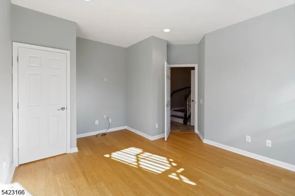 a view of a room with wooden floor