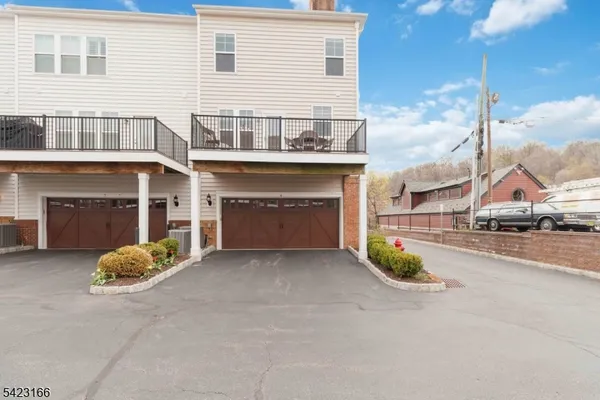 a view of a house with a yard and garage