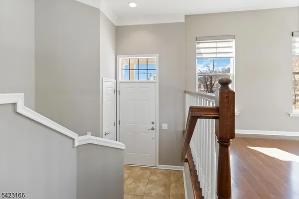 a view of entryway with wooden floor and staircase