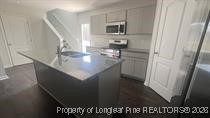 228 Fire Lane Vass, NC 28394 - Photo 14 of 27 a kitchen with a sink and cabinets