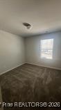 228 Fire Lane Vass, NC 28394 - Photo 20 of 27 an empty room with wooden floor and windows