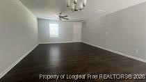 228 Fire Lane Vass, NC 28394 - Photo 9 of 27 en empty room with wooden floor and window