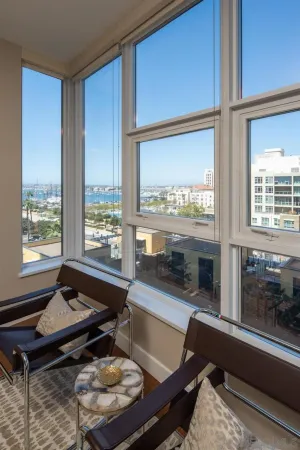 a bedroom with a bed and a large window