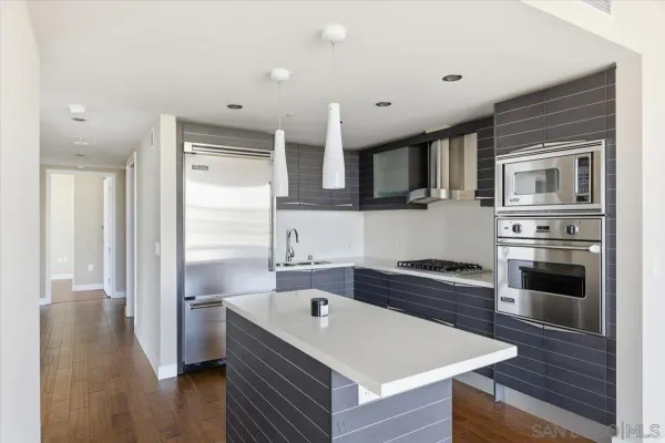 a view of open kitchen with granite countertop cabinets and window