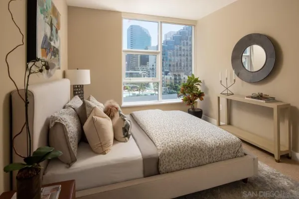 a bedroom with a bed dresser and a window