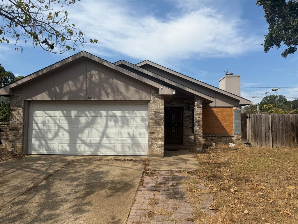 10823 Addie Road Dallas, TX 75217 - Photo 2 of 20 Brick facade with a prominent front-facing gable and an attached two-car garage