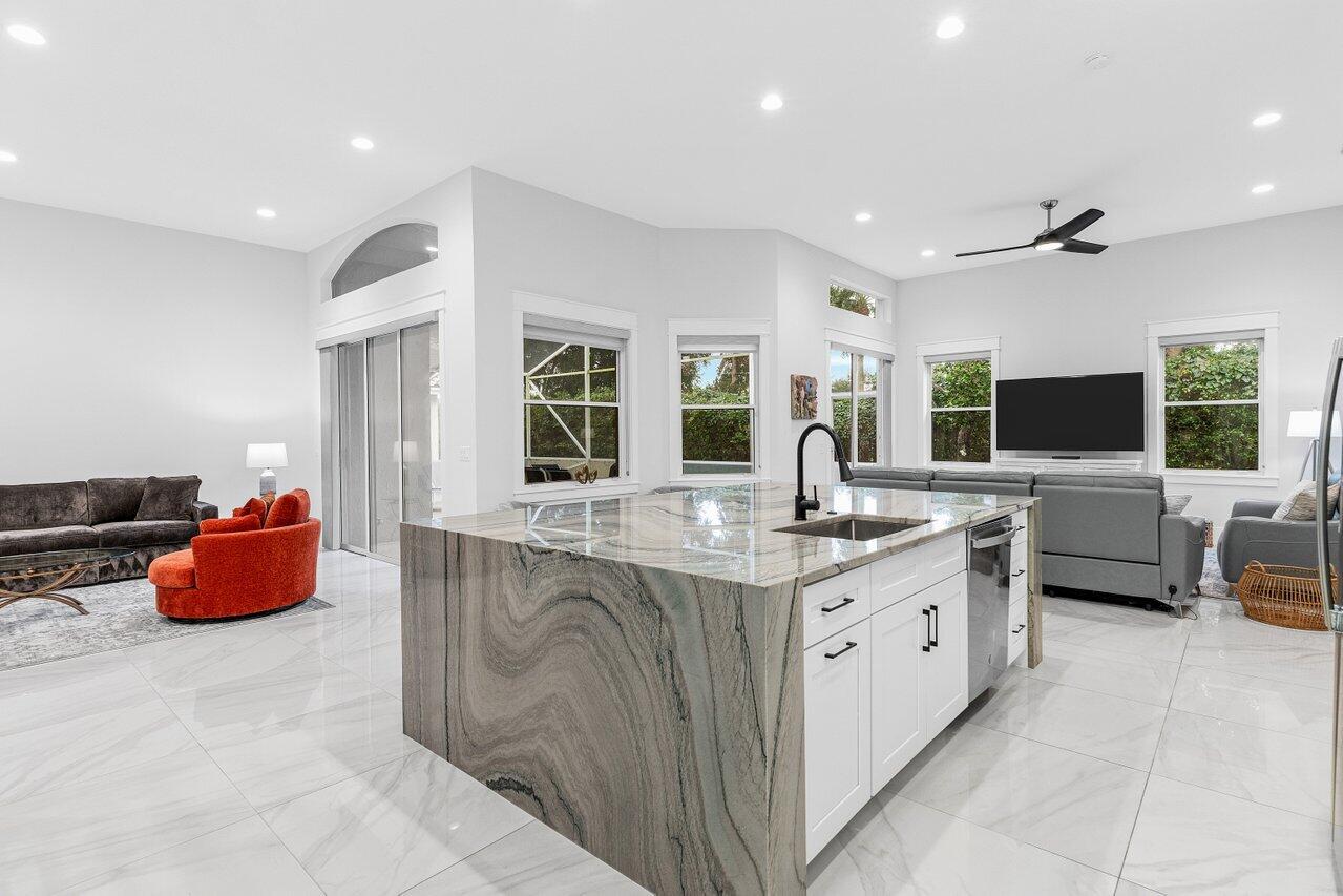 7320 Falls Road West Boynton Beach, FL 33437 - Photo 14 of 29 a spacious kitchen with stainless steel appliances granite countertop a sink and cabinets