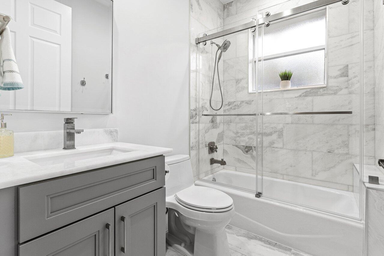 7320 Falls Road West Boynton Beach, FL 33437 - Photo 26 of 29 a bathroom with a sink a toilet and shower